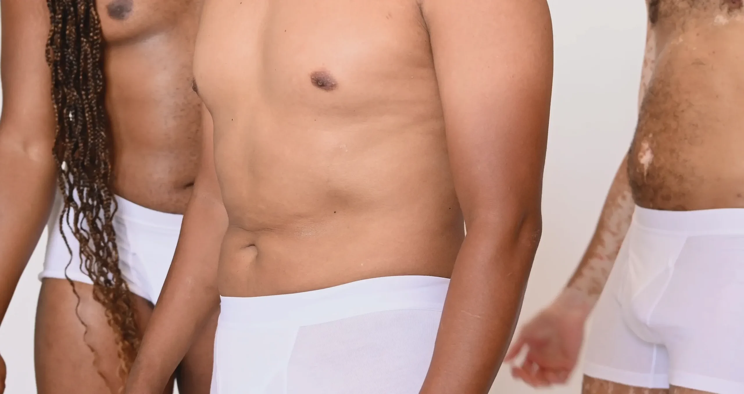 Three men wearing white Majella underwear