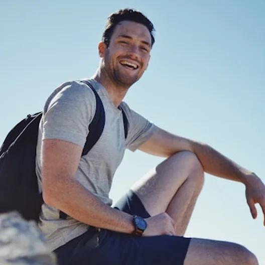 Smiling man resting outdoors