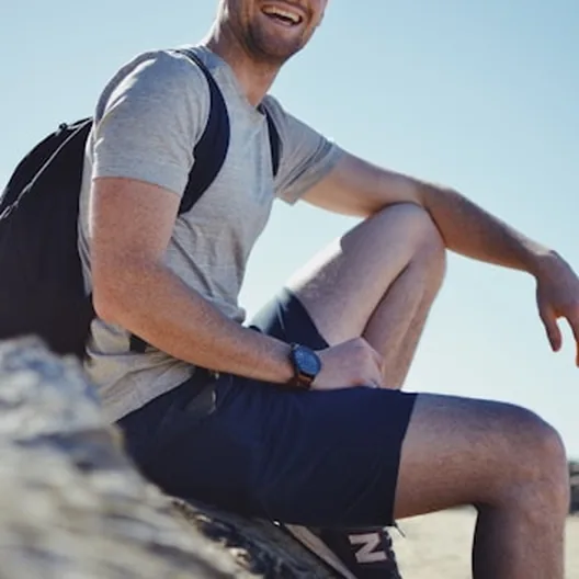 Smiling man resting outdoors